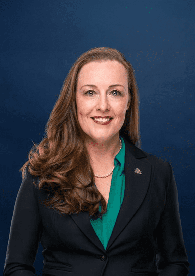 Smiling professional woman wearing blazer and pearls
